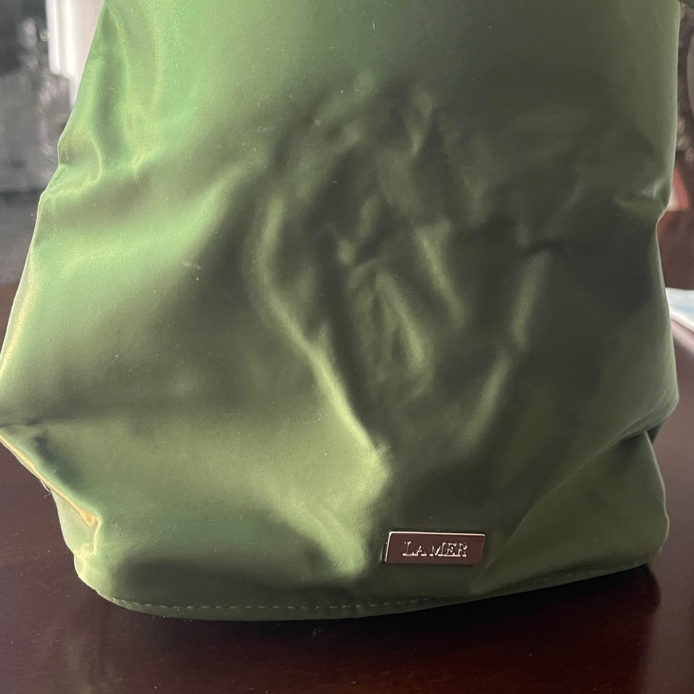 Vibrant Green Glossy Cosmetic bag from LAMER with Unstructured Design